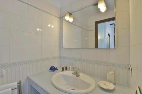 uma casa de banho branca com um lavatório e um espelho em Argelati em Milão