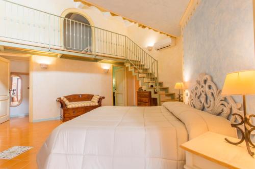 a bedroom with a large white bed and a staircase at Residenza Sveva in Termoli