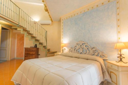 a bedroom with a large bed and a staircase at Residenza Sveva in Termoli