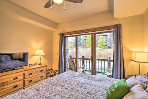 a bedroom with a bed and a television and a balcony at Cozy Crested Butte Condo 50 Yards from Ski Lift! in Mount Crested Butte