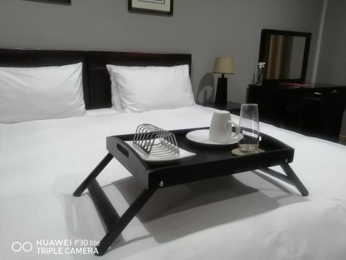 a black coffee table in front of a bed at The Penthouse in Port Edward