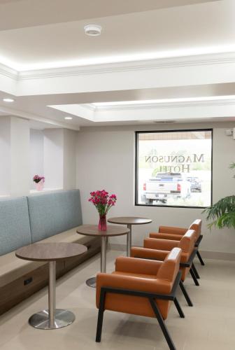 a waiting room with tables and chairs at Spark by Hilton Fishkill in Fishkill