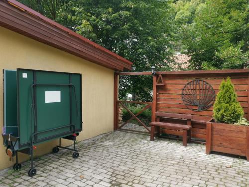 a patio with a bench and a gate and a fence at Privát Adriana in Kremnica