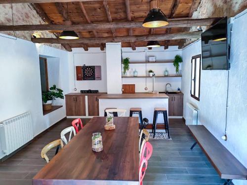 a large kitchen with a wooden table and chairs at Casa rural El Molino de Bogarra in Bogarra