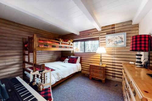 a bedroom with a bunk bed and a piano at Lake Tahoe Cabin Perfection in Tahoma
