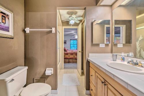 a bathroom with a sink and a toilet and a mirror at Canalfront Homosassa Escape with Private Dock! in Homosassa