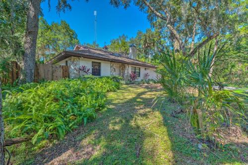 a cottage in the woods with a garden at Private Dock Canal-Front Homosassa Home! in Homosassa
