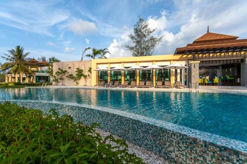 a large swimming pool in front of a building at Ataman Luxury Villas in Ko Kho Khao