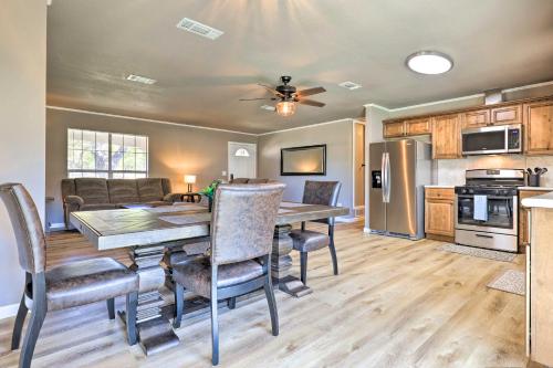 a kitchen and dining room with a table and chairs at Quiet Haven with Hot Tub, 4 Mi to Canyon Lake! in Fischer