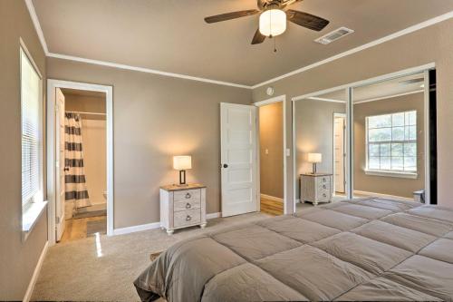 a bedroom with a large bed and a ceiling fan at Quiet Haven with Hot Tub, 4 Mi to Canyon Lake! in Fischer