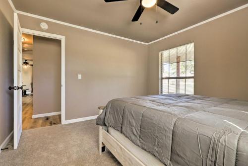 a bedroom with a bed and a ceiling fan at Quiet Haven with Hot Tub, 4 Mi to Canyon Lake! in Fischer