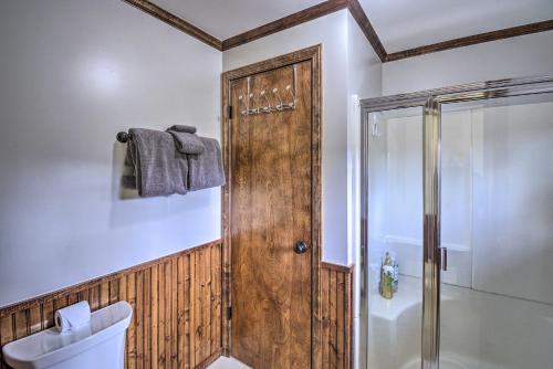 a bathroom with a shower and a wooden door at Spacious Home with Yard, 20 Miles to Olympic NP in Sequim