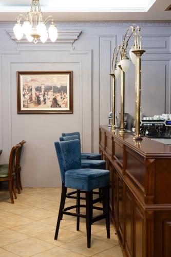 a room with a desk with two chairs and a mirror at Chopin Hotel in Lviv