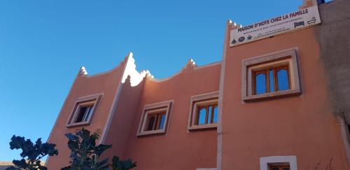 an orange building with a blue sky in the background at Maison D'hote Chez La Famille in Tamellalt