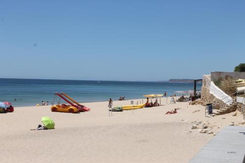 a group of people on a beach with the ocean at Casa Dos Cedros in Lagos