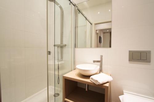 a bathroom with a sink and a shower at Appartements Urban et Pure in Cannes