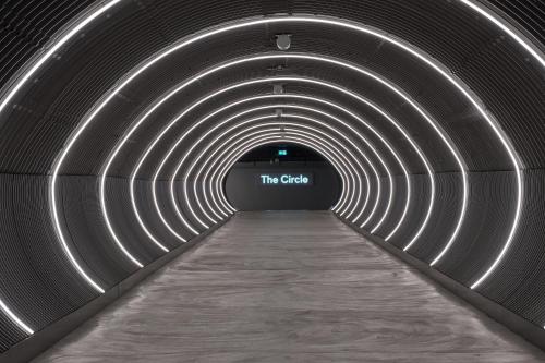 a tunnel with a sign that reads the catch at Hyatt Place Zurich Airport the Circle in Kloten