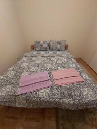a bedroom with a bed with two pink sheets at Ino 99 in Užice