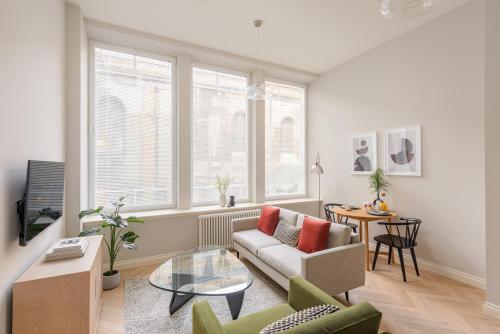 a living room filled with furniture and a window at Museum Apartments in Edinburgh