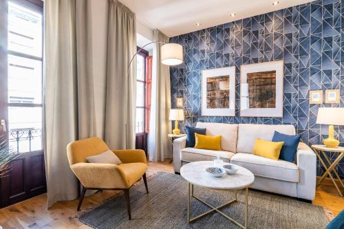 a living room with a couch and chairs and a table at tuGuest Isabel la Catolica Apartment in Granada