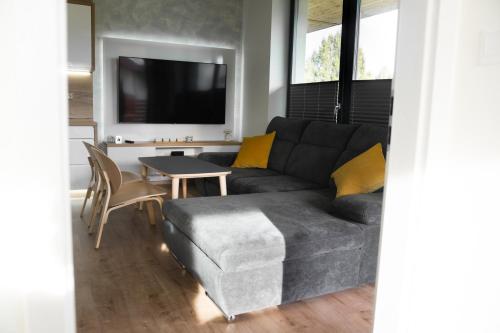 a living room with a couch and a table at Ubytování v Beskydech - Apartmán Kája in Čeladná