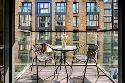 a table and two chairs on a balcony with a building at City View Apartments in Birmingham