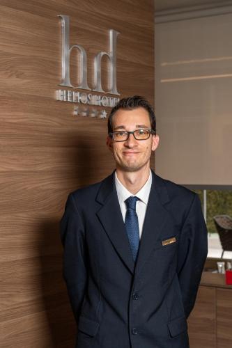 a man wearing glasses and a suit and tie at Helios Hotel in Monza