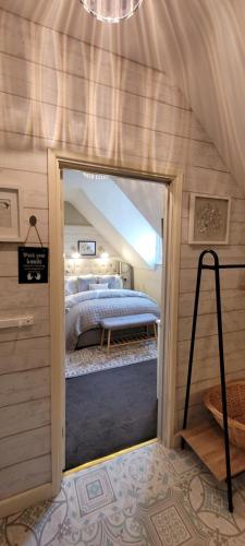 a bedroom with a bed and a mirror in a room at Rigsbys Guesthouse Doncaster in Doncaster