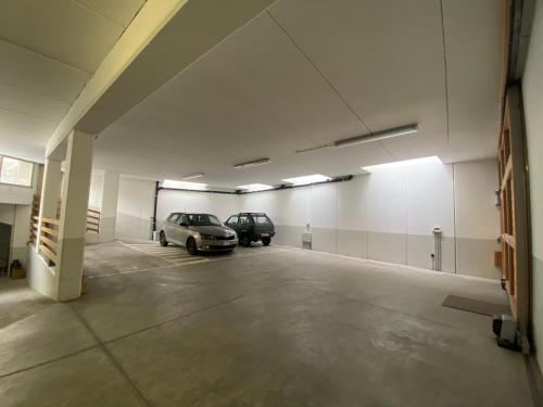 a parking garage with two cars parked in it at Chalet dei Reparti Bormio in Bormio