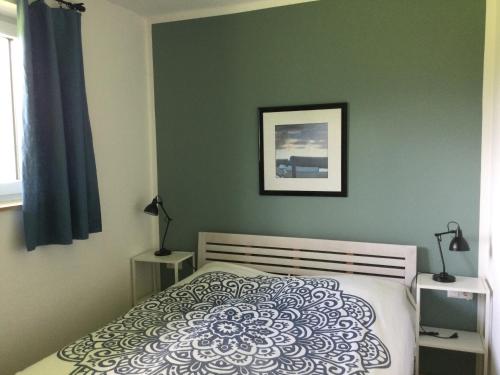a bedroom with a bed and a picture on the wall at STEINERGUT Gartenwohnung 1 in Vorderstoder