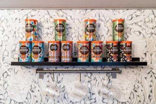 a shelf with cans of beer on a wall at Rigsbys Guesthouse Doncaster in Doncaster