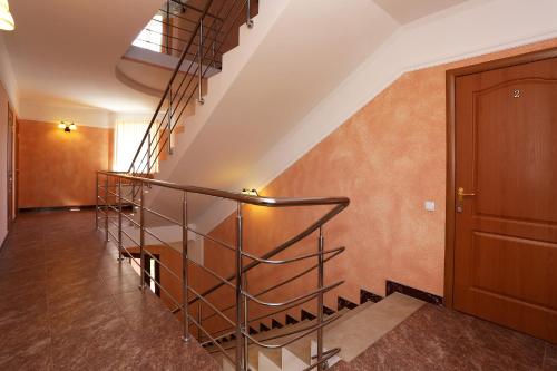 a spiral staircase in a home with orange walls at Casablanca Guest House in Koktebel