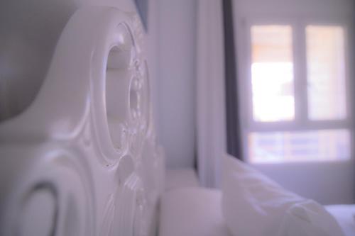 a close up of a white door with a window at Oceanum Visum Spa Deluxe in El Trocadero