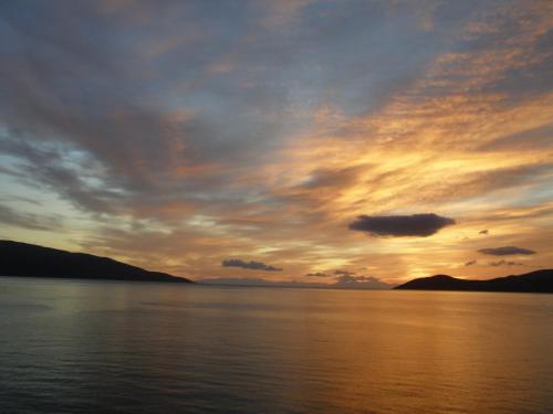 a sunset over a large body of water at Ritsa House in Ayia Evfimia