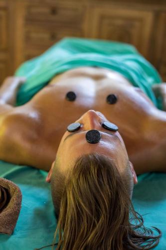 a man laying on a bed with pills on his face at Namuwoki Lodge in Puerto Viejo