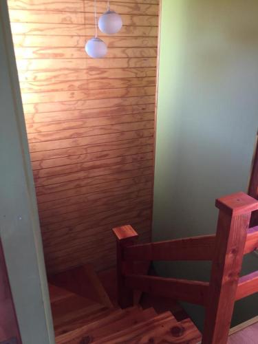 a room with a wooden shower with two wooden benches at CASAS Y CABAÑAS CUMBRES DEL SOL in Castro
