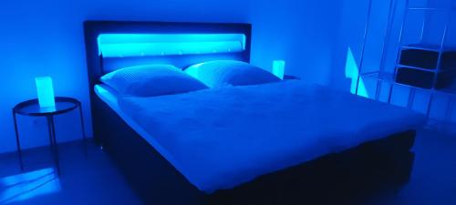 a bedroom with a bed with a blue light at NEW LOOK in Frankenberg