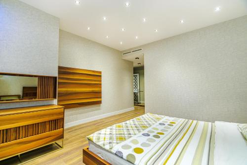 a bedroom with a bed and a dresser at Baku Fantastic Port Baku Residance in Baku