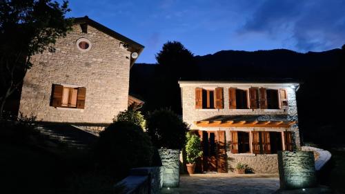 a large stone building with windows on the side of it at Casa Rivetta in Valmareno