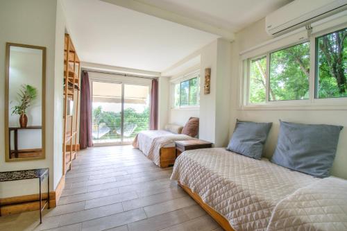 a bedroom with two beds and a window at Funky Monkey Lodge in Santa Teresa Beach