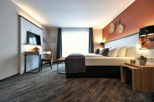 Ένα ή περισσότερα κρεβάτια σε δωμάτιο στο Christinenhof & Spa - Wellnesshotel am Rande des Spreewalds