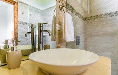 a bathroom with a large white sink and a tub at Funky Monkey Lodge in Santa Teresa Beach