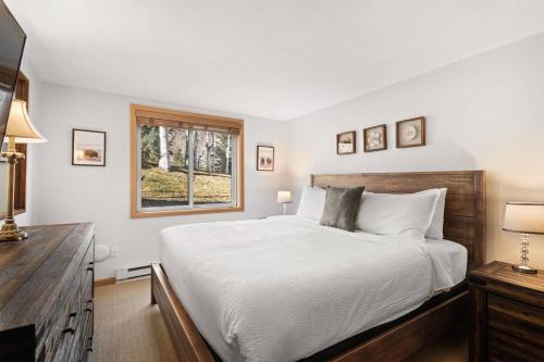 a bedroom with a large bed and a window at Terracehouse 81 in Snowmass Village