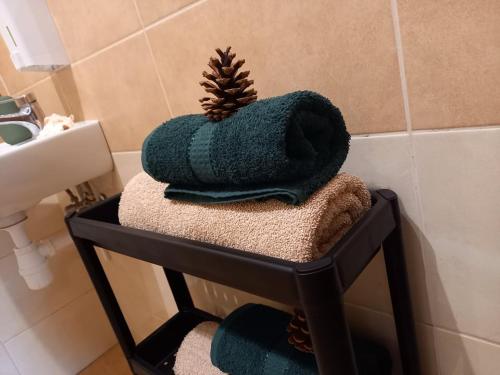 a pile of towels on a shelf in a bathroom at Tawerna-Stawiska in Garbatka-Letnisko