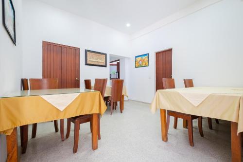 a dining room with two tables and chairs at Hotel Victoria Comfort in Bucaramanga