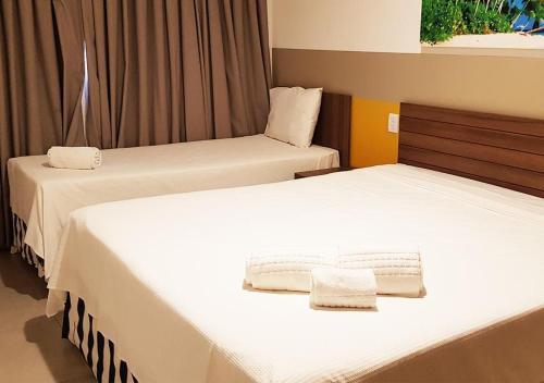 En eller flere senge i et værelse på Olimpia Park Resort - Em frente à portaria do Thermas dos Laranjais