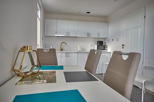 a kitchen with a dining room table and chairs at Domek na Roztoczu Sauna & Jacuzzi in Horyniec