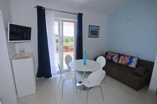 a living room with a table and a couch at Solaria Apartments Porec in Poreč
