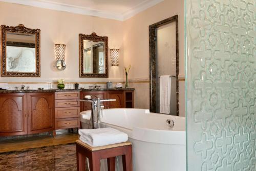 a bathroom with a tub and a sink at Shangri-La Qaryat Al Beri, Abu Dhabi in Abu Dhabi