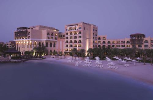 a large building with white chairs in front of it at Shangri-La Qaryat Al Beri, Abu Dhabi in Abu Dhabi